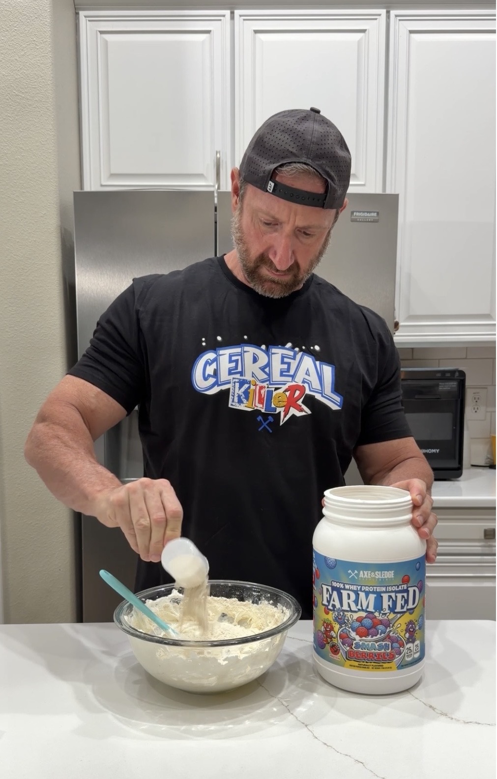 Dean Perrone preparing Axe & Sledge Farm Fed whey protein in the kitchen — Dean Perrone Gen X UGC Creator
